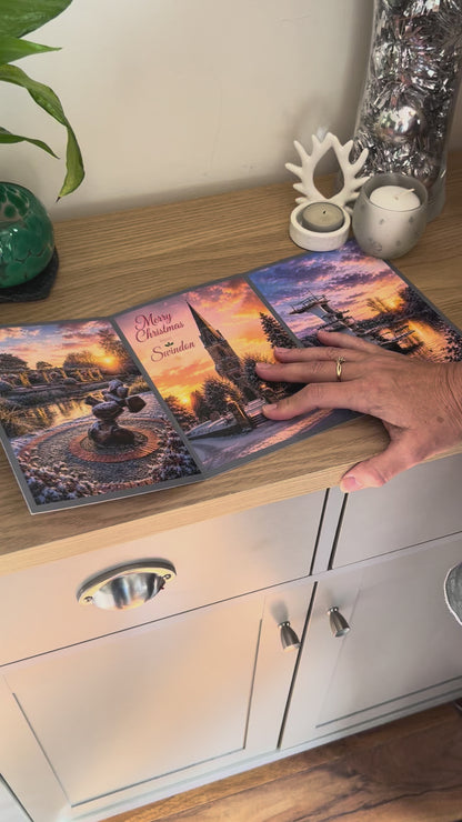 Demonstration of the Bare Cards Christmas Card for Swindon, showing how to write, fold seal, open and display the self-sealing card. This triptych card shows  festive images of Queen's Park, Christchurch and Coate Water at dusk.
