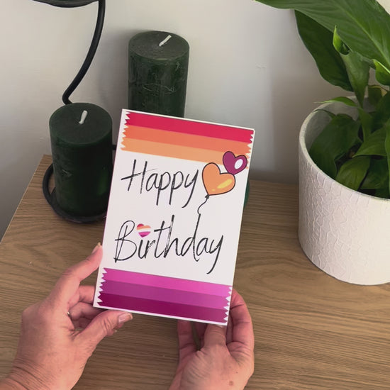 Video shows a demonstration of the Bare Cards Lesbian Birthday Card. Video shows how to fold and seal card to reveal built-in 'envelope' in Pride Flag colours.