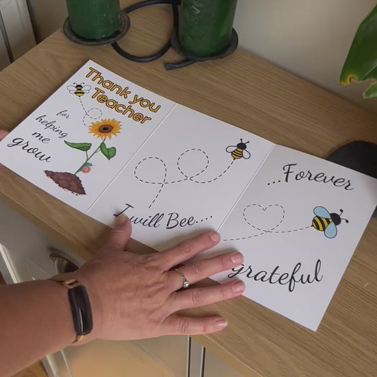 Video shows a demonstration of the Bare Cards thank you teacher card with images of a sunflower and bee and the caption "Thank you teacher for helping me grow. I will bee forever grateful". The video shows how to fold and seal this eco friendly card by removing the adhesive strip and fixing to the front of the card.