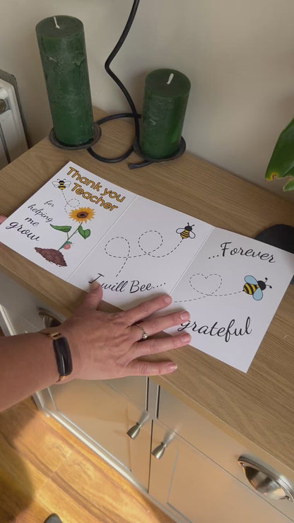 Video shows a demonstration of the Bare Cards thank you teacher card with images of a sunflower and bee and the caption "Thank you teacher for helping me grow. I will bee forever grateful". The video shows how to fold and seal this eco friendly card by removing the adhesive strip and fixing to the front of the card.