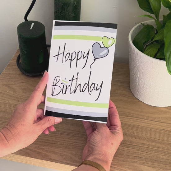 Video shows a demonstration of the Bare Cards Agender Birthday Card. Video shows how to fold and seal card to reveal built-in 'envelope' in Pride Flag colours.