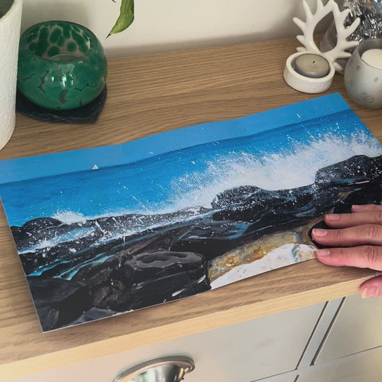 A demonstration video for the self-sealing greetings card 'Seascape on the Rocks' from the Sue O'Sullivan Art Collection. The video shows how to write, fold, seal, address, open and display this trifold card.
